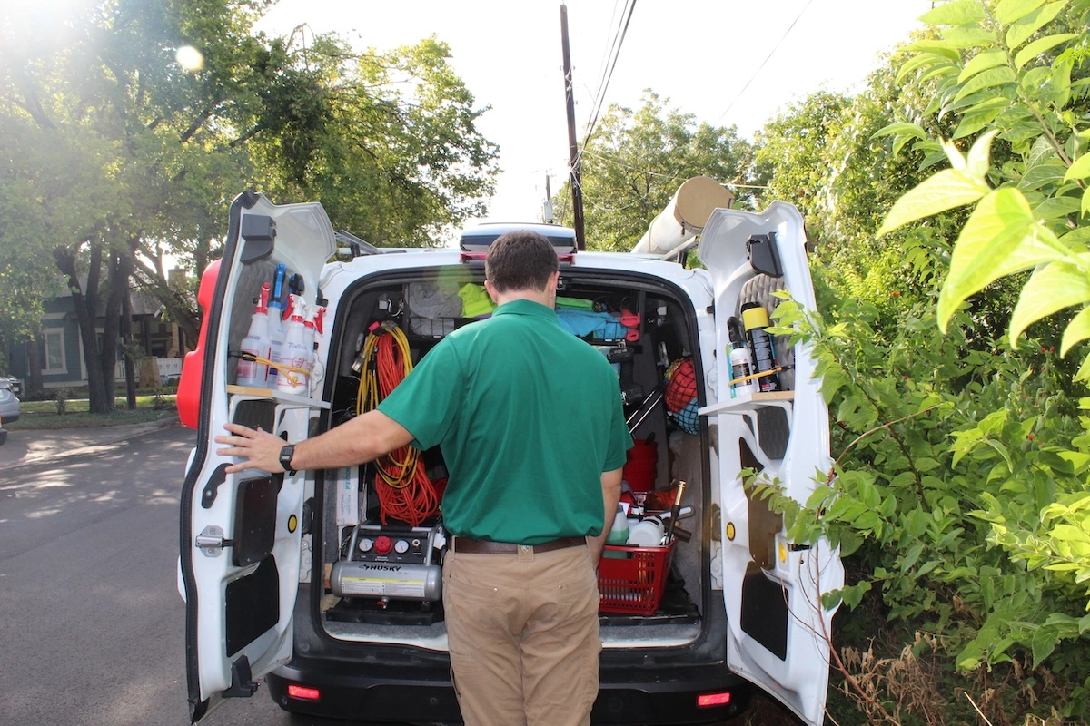 Man opening back of mobile detailing van