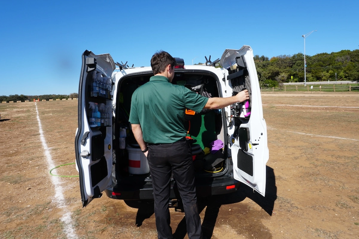 Man opening back of mobile detailing van